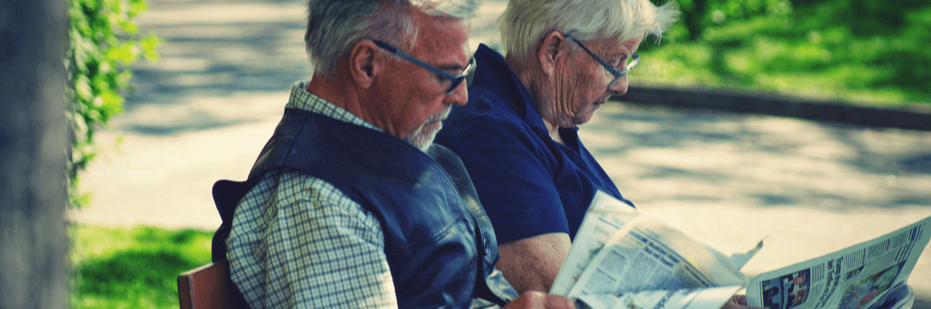 seniors reading newspaper
