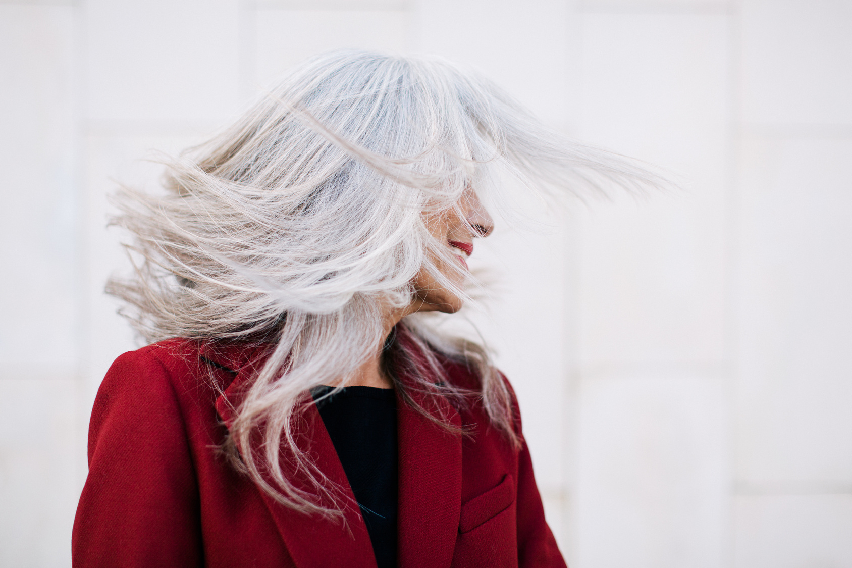 Woman flips grey hair.