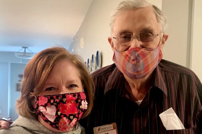 Amy and Bob Palme pose together witih masks.