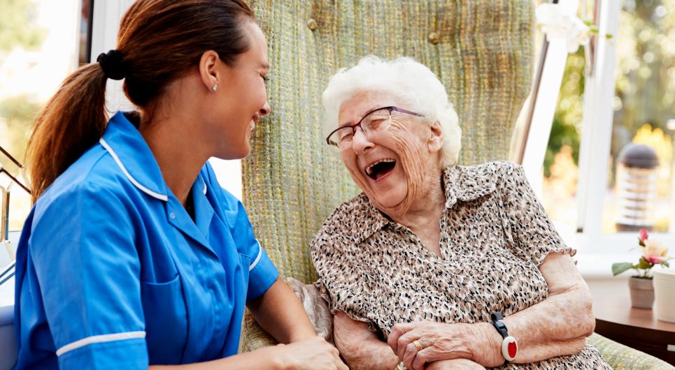 Older adult and care partner laughing