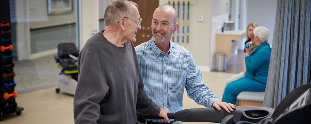 Rehab resident and therapist during physical therapy session in rehab gym