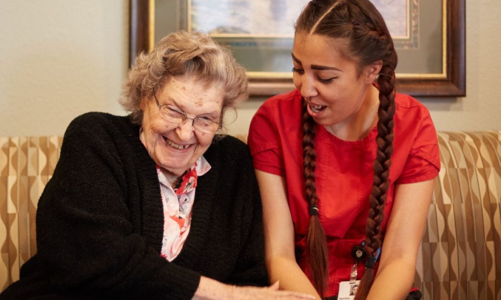 Resident and care partner laughing