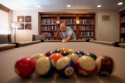 Clermont Park Resident Playing Pool in Billiards Room